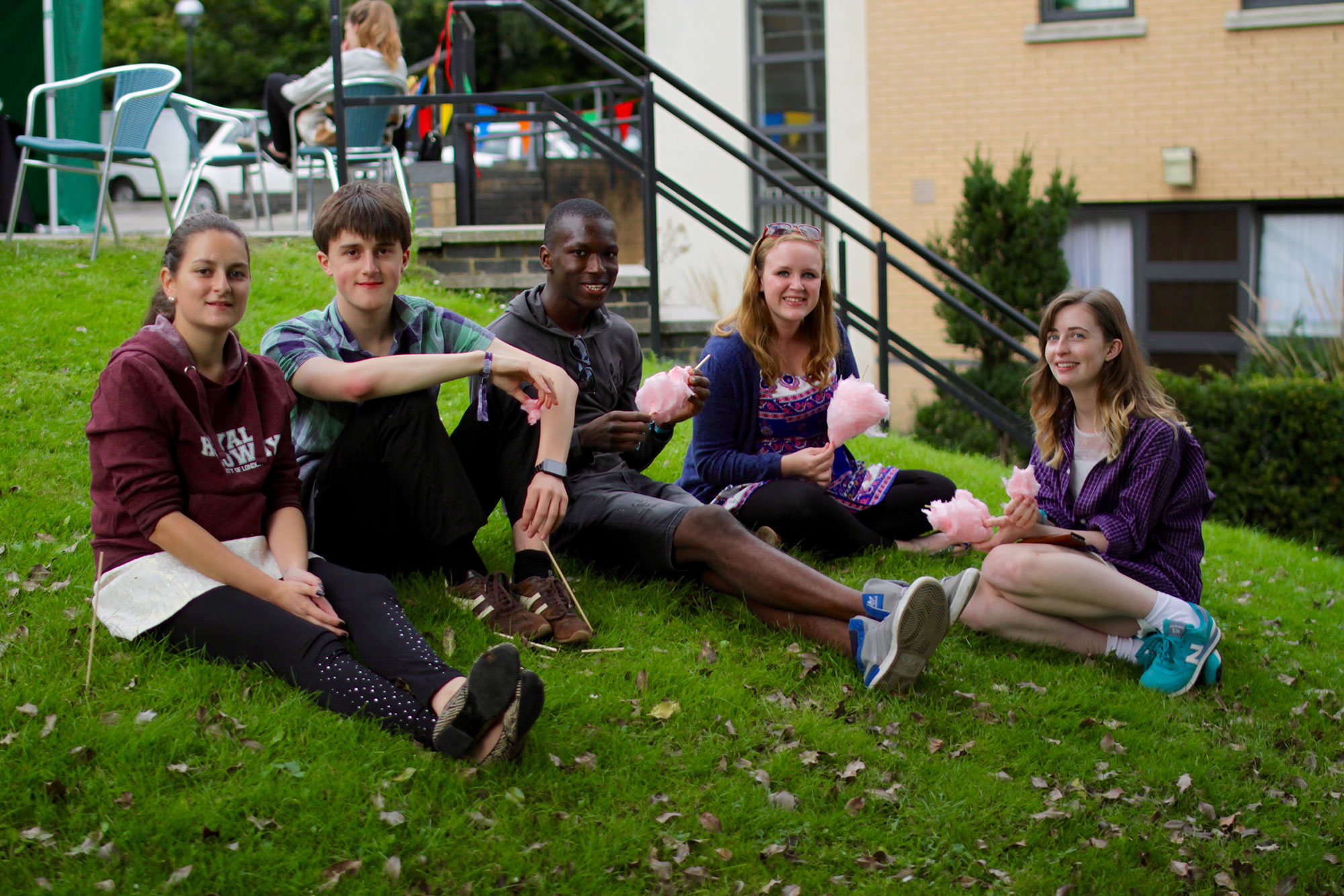 Students relaxing on a lawn at Kingswood