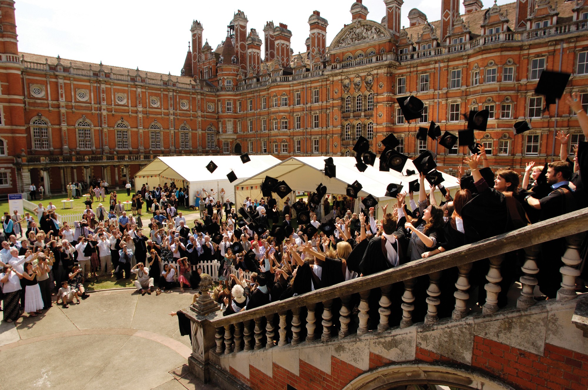 Graduands throwing hats in the air in the South Quad at Graduation