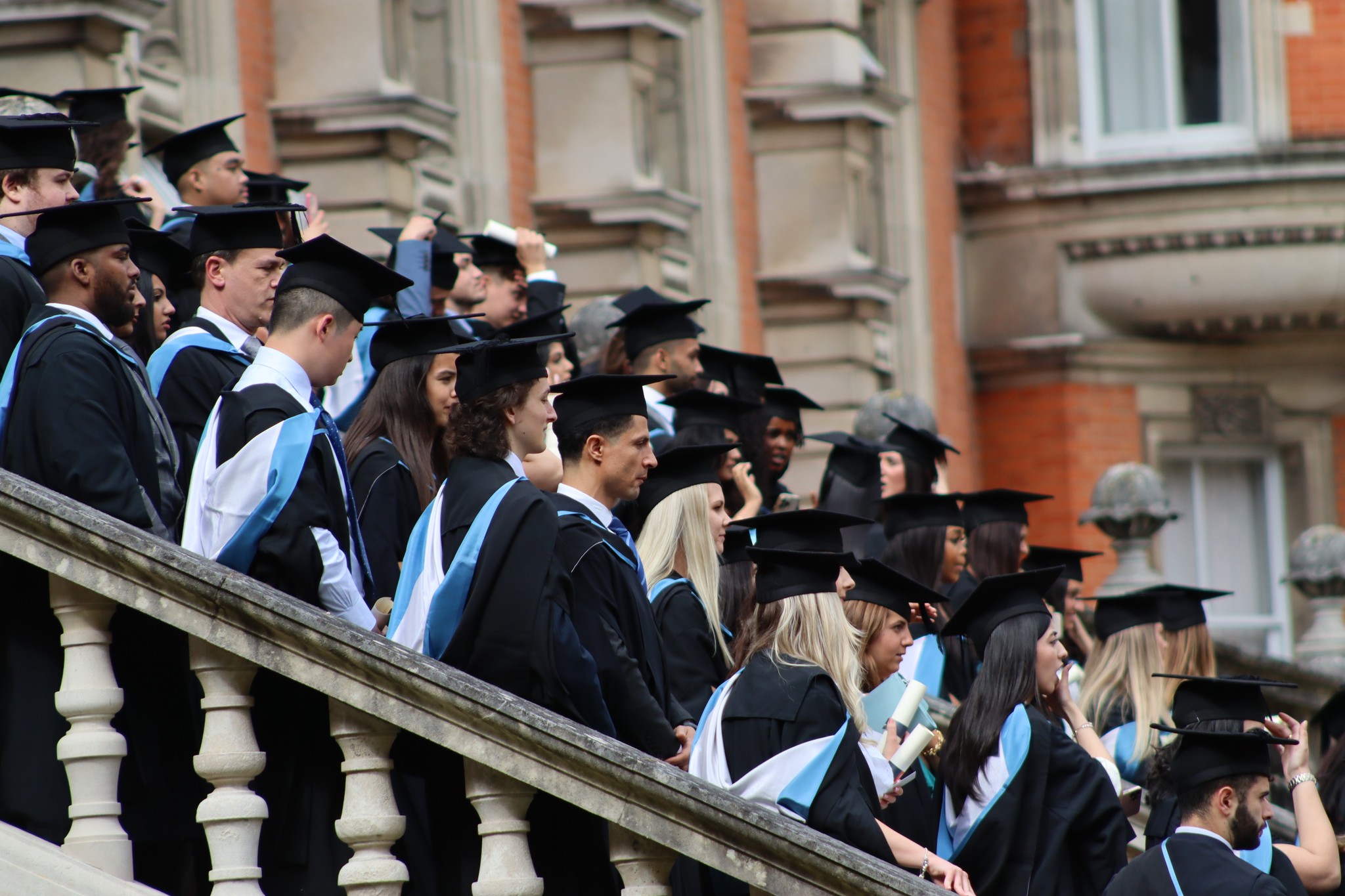 Graduates lined in rows on the Founder's quad steps with caps