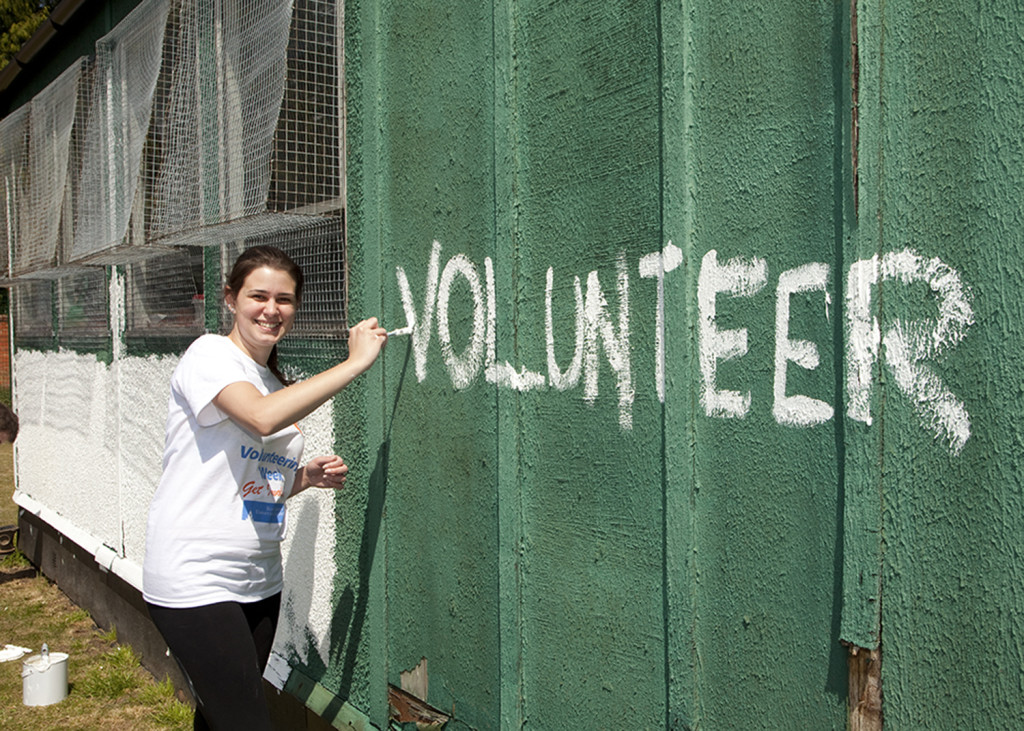 Painting volunteer on a wall